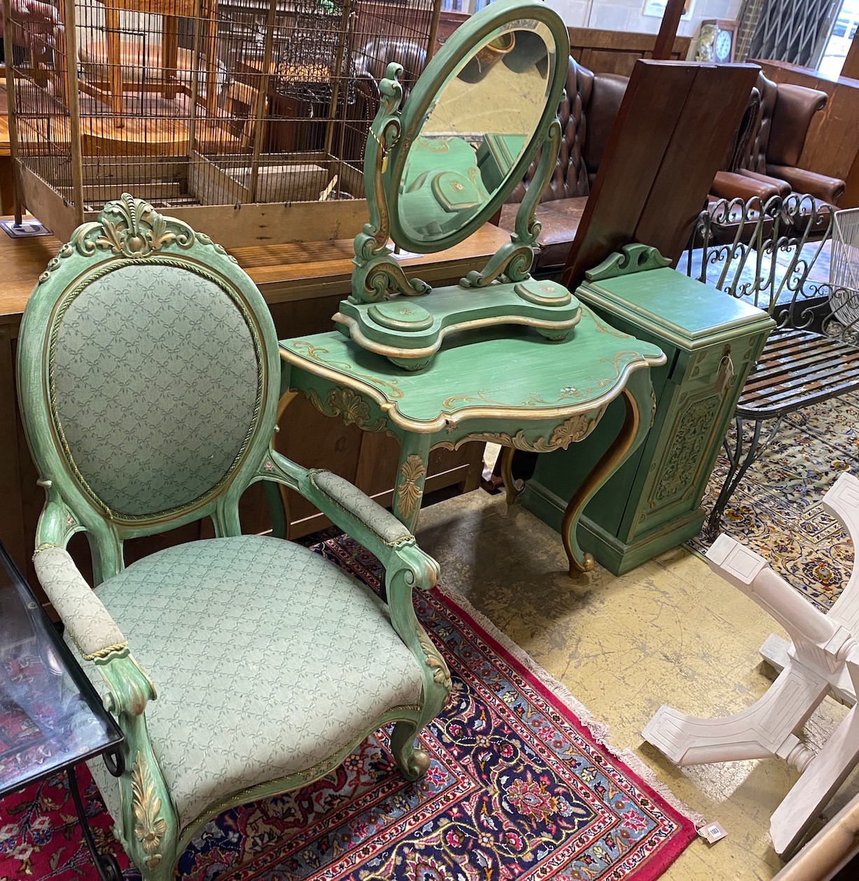 A Victorian style mahogany open armchair, together with a side table, dressing mirror and bedside cupboard, all painted green